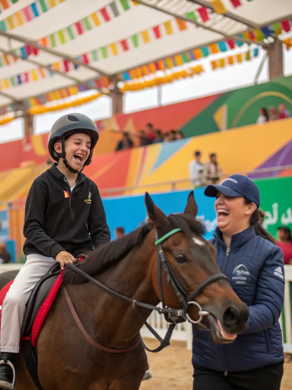 A young girl with a disability smiles brightly as she confidently rides a horse with the support of an instructor. The scene is set in a sunny, green field, emphasizing the therapeutic and inclusive nature of the equestrian program.